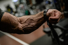 Strong Forearm With Vein And Strap Of Bodybuilder Athlete Male During Sport Fitness Gym Training