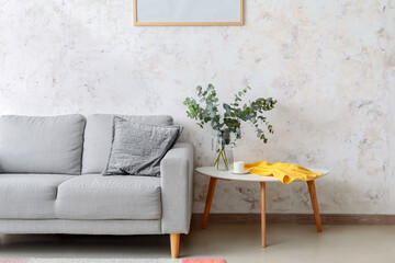 Wall Mural - Vase with eucalyptus branches and cup of coffee on table in living room