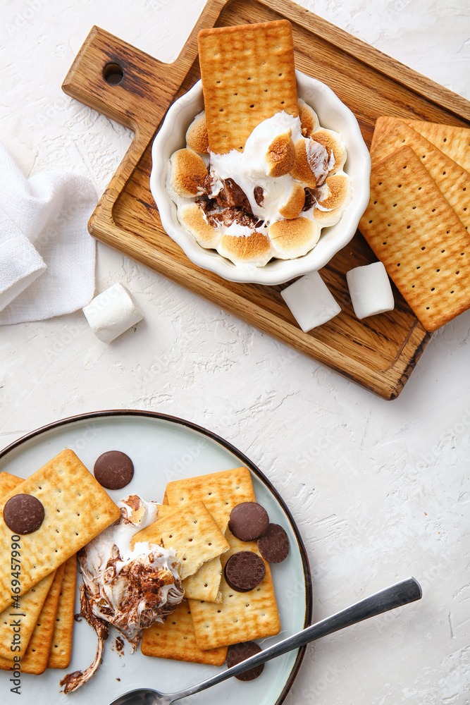 Composition with tasty S'mores dip and crackers on white background