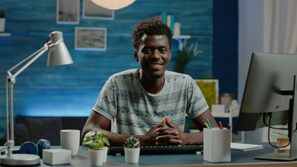 Poster - Portrait of entrepreneur prepared for remote work on computer at desk. Corporate employee looking at camera and smiling, working from home using technology. Business worker in workspace
