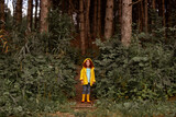 Fototapeta Na ścianę - Smiling red haired girl standing in forest