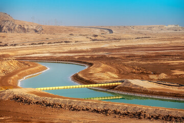 Fototapete - Canal with water from the Dead Sea in the desert, Israel