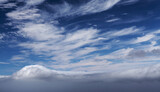 Fototapeta Londyn - shot from Gran Canaria, the very tip of Teide just visible over low sea of clouds, high cirrus above 