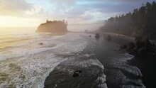 Flying Over Ruby Beach At Sunset, Oregon, United States. Magnificent Black Beach In Fog, Cliffs And Waves Of The Pacific Ocean. Aerial Drone Shot