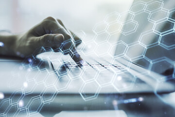 Poster - Creative concept of wireless technology with hexagon hologram and hands typing on laptop on background. Big data and database concept. Multiexposure