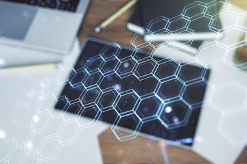 Aufkleber - Creative abstract wireless technology hologram with hexagon and modern digital tablet on desktop on background, top view, artificial intelligence and machine learning concept. Multi exposure
