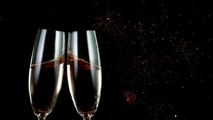 Canvas Print - Super slow motion of having a toast with two champagne glasses. Glittering particles. Isolated on black background. Filmed on high speed cinema camera, 1000 fps.