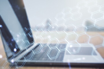 Poster - Double exposure of technology hologram with hexagon on laptop background. Research and development software concept