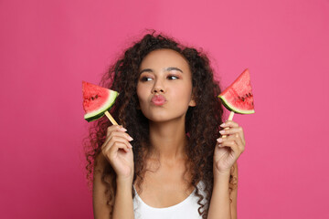 Poster - Beautiful young African American woman with pieces of watermelon on crimson background