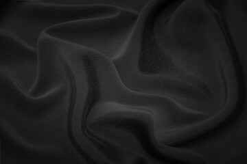 Black fabric texture background, wavy fabric slippery black color, luxury satin or silk cloth texture.
