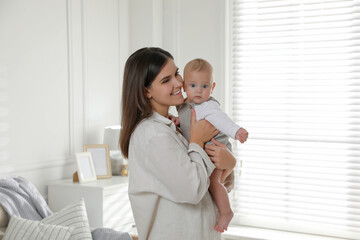 Poster - Young woman with her little baby near window at home