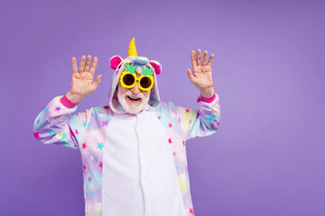 Portrait of attractive cheerful grey-haired man fooling dancing having fun isolated on violet purple color background