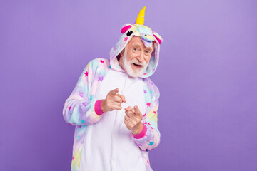 Sticker - Portrait of attractive cheerful grey-haired man dancing moving pointing at you isolated over violet purple color background