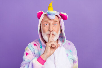 Sticker - Portrait of attractive mysterious grey-haired man wearing kigurumi showing shh sign isolated over violet purple color background