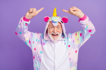 Sticker - Portrait of attractive cheerful childish grey-haired man demonstrating kigurumi having fun isolated over violet purple color background