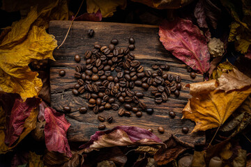  autumn leaves with coffee beans on rustic wood