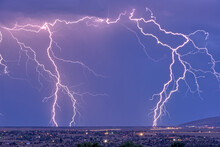 Lightning Bolts Striking Prescott Area In The Distance With The Town Of Chino Valley Just North Of Prescott Town In The Foreground, Arizona