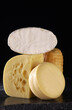ripening and hard yellow cheeses on a black background