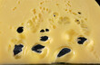 slices of Goudy yellow cheese on black background