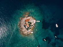 Boats Stand Near The Island Of Otocic Gospa. Montenegro. Drone