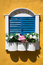 Flowers With Blue Shutters On House Window, Emborio Harbor, Halki (Chalki) Island, Dodecanese Group, Greek Islands