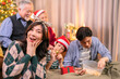 © whyframeshot - asian adult male give present box to hie parent in christmas holidays while using smartphone talking selfie photo happiness together at living room on sofa couch,family relation bonding home interior