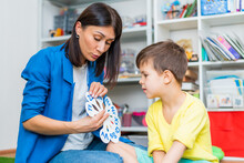 A Cute Boy With A Speech Therapist Is Taught To Pronounce The Letters, Words And Sounds.
