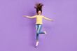 © deagreez - Full body photo of young lovely girl jump up wear casual clothes dream active isolated over violet color background