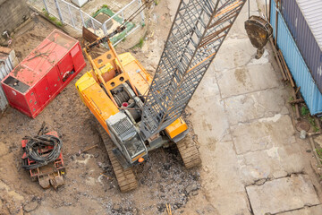 Wall Mural - Construction crane boom on crawler tracks, aerial view.