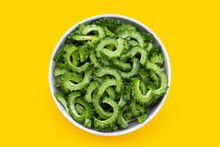 Sliced Bitter Gourd In White Bowl On Yellow Background.