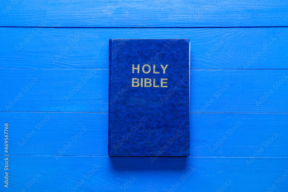 Holy Bible on blue wooden background