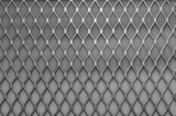 Fototapeta  - Metal grid with geometric pattern of rhombi, background. Black metallic modern background