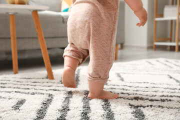 Sticker - Legs of baby girl learning to walk at home, closeup