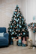 New Year's cozy home interior with a Christmas tree and garlands. the concept of decorating the living room in the house: pink and blue color of toys. artificial christmas tree. 