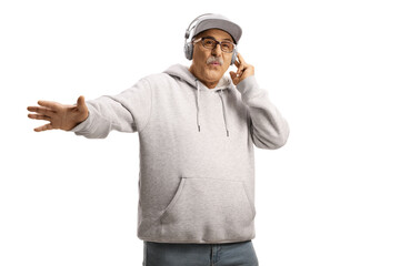 Poster - Cheerful mature man with a cap listening music with headphones