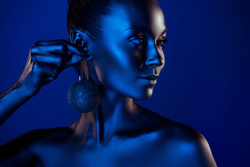 Close up photo of aesthetic lady x-mas tree toy earring look empty space discount ad isolated on dark blue background