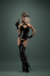 © Warpedgalerie - Pretty tattooed young woman wearing latex lingerie, cap and gun