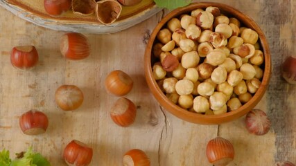 Wall Mural - Hazelnuts harvest. Whole and shelled organic hazelnuts.Healthy fats.View from above. Farmed organic ripe hazelnuts. 4k footage