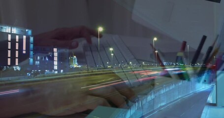 Poster - Animation of hands working on laptop over sped up traffic in city at night