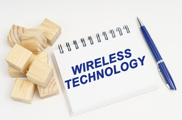 Poster - On the table are cubes, a pen and a notebook with the inscription - Wireless Technology