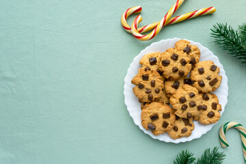 Wall Mural - Christmas cookies with chocolate chips on blue textile background, space for text