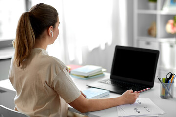 Poster - distant education, remote job and people concept - female math teacher with laptop computer and earphones working at home office