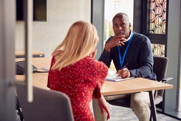 Female University Or College Student Having Individual Meeting With Tutor Or Counsellor