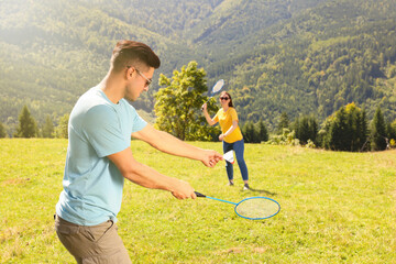 Poster - Couple playing badminton in mountains on sunny day