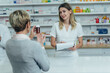 © Zamrznuti tonovi - Pharmacist giving prescription medications to smiling senior female customer