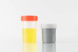 Yellow color urine sample and stool container specimen bottle for check signs of common conditions or diseases on white background.