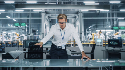 Poster - Confident Engineer in White Shirt Making Gestures of Moving Invisible Object in Virtual Reality in an Office at Car Assembly Plant. Industrial Specialist Working in Technological Development Facility.