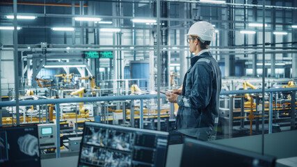 Poster - Handsome Engineer in Uniform and Hard Hat Using Tablet Computer at a Car Assembly Plant. Industrial Specialist Working on Vehicle Design, Overlooking Production in Technological Facility.