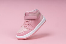 Pink Child Shoe On Pink Background. Children's Shoe For Girls