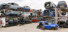 Old Rusty Corroded And Crushed Cars In Car Scrapyard. Car Recycling.  Ecological Concept By Dump Of Wrecked Cars.